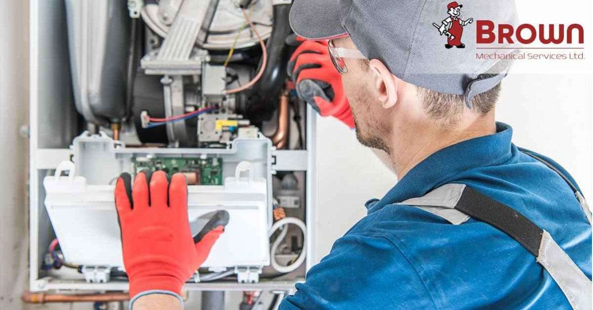 Skilled Worker performing Furnace Maintenance, Inspecting and Cleaning Components.